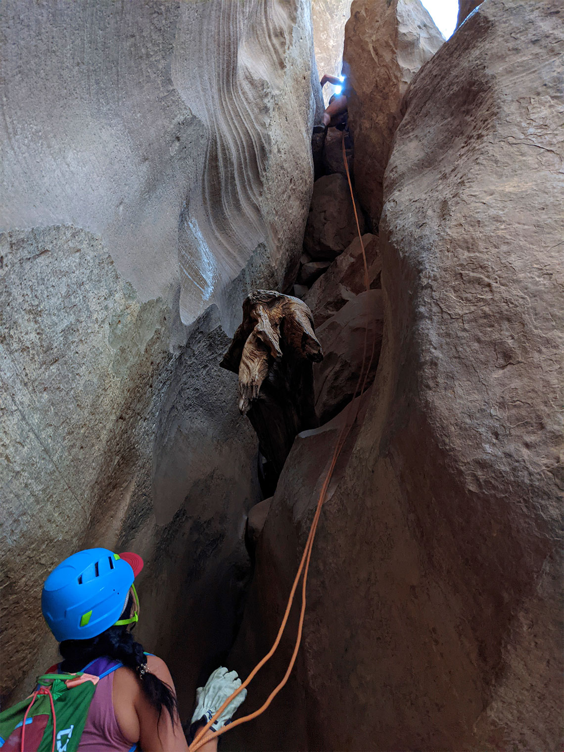 Person belaying at the bottom of the 3rd rappel in Englestead Canyon