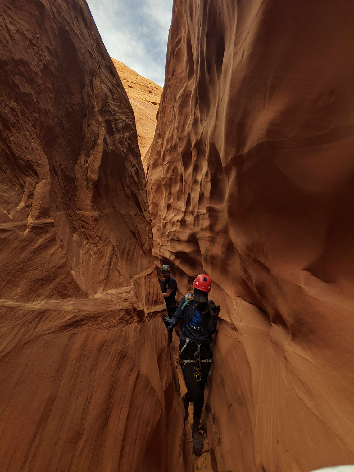 Squeezing through the right fork of Leprechaun slot canyon